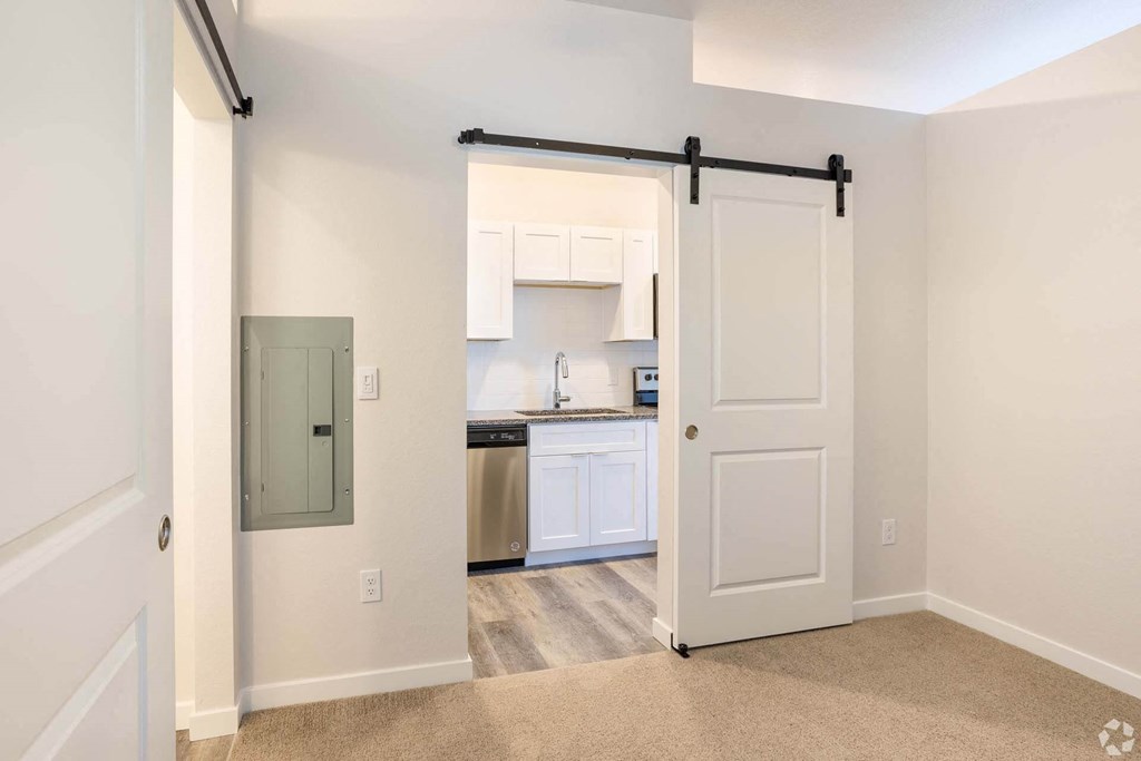entry to kitchen with sliding white door at Brownstones at Palisade Park Townhomes, Broomfield, CO