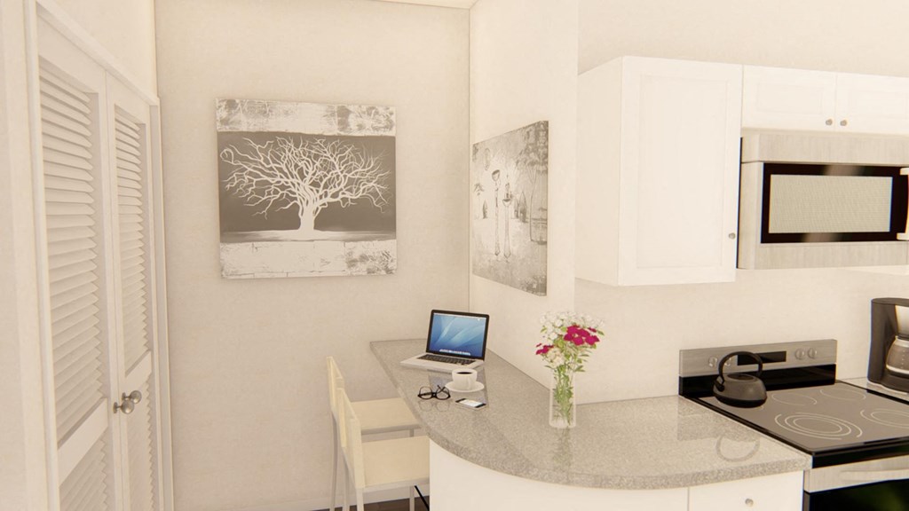 a kitchen with a desk and a microwave at Brownstones at Palisade Park, Broomfield Colorado