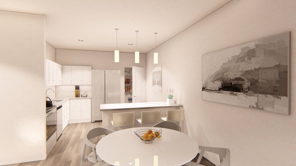 a kitchen with white cabinetry and a white dining table with four chairs at Brownstones at Palisade Park Townhomes, Broomfield, CO
