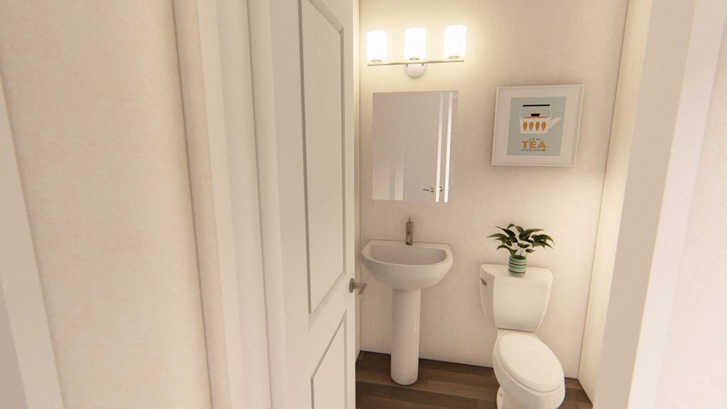 a small bathroom with a toilet sink and mirror at Brownstones at Palisade Park Townhomes, Broomfield