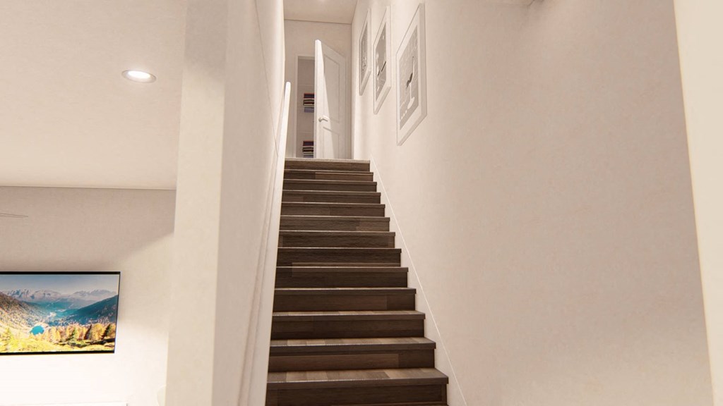 a staircase in a home with white walls and wood treads at Brownstones at Palisade Park Townhomes Broomfield Colorado