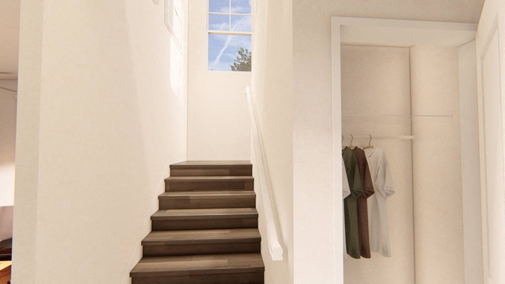 a stairwell in a home with white walls and a window with a white curtain at Brownstones at Palisade Park Townhomes, Broomfield, CO