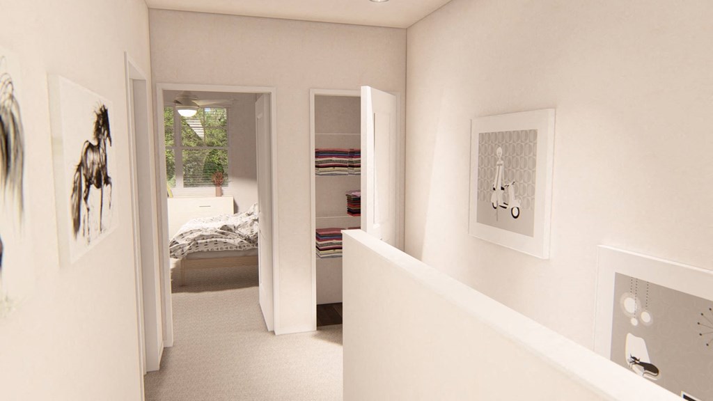 a view from the bottom of the stairs looking into the bedroom and bathroom at Brownstones at Palisade Park, Broomfield, 80023
