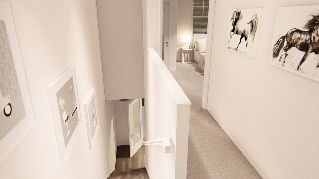 a hallway with white walls and pictures on the wall at Brownstones at Palisade Park Townhomes, Broomfield Colorado