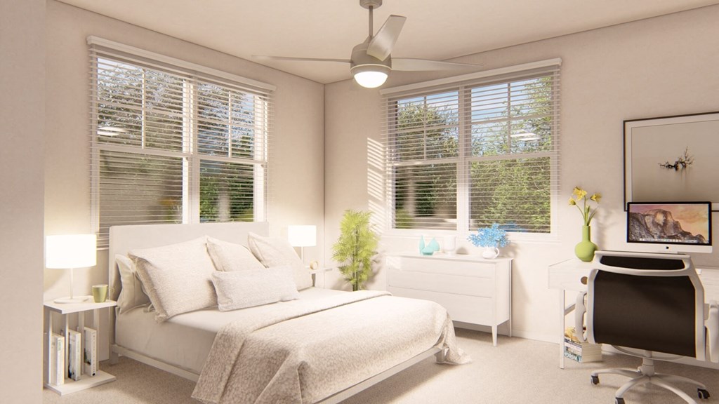 a bedroom with a bed and a desk with a computer at Brownstones at Palisade Park Townhomes, Broomfield Colorado
