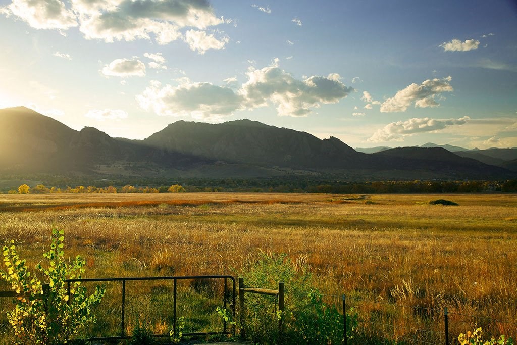 a field with a mountain in the background at Brownstones at Palisade Park Townhomes, Broomfield, 80023