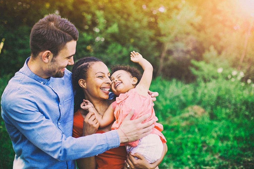 a man and woman holding a baby at Brownstones at Palisade Park Townhomes, Colorado, 80023