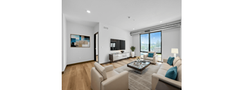 a living room with white furniture and a large window