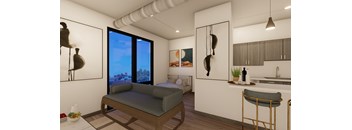 A modern living room with a couch, a bed, and a kitchen area.