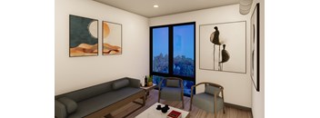 A living room with a grey sofa, two chairs, a coffee table, and three framed pictures on the wall.