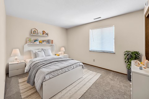 A bedroom with a large bed and a window with a blue curtain.