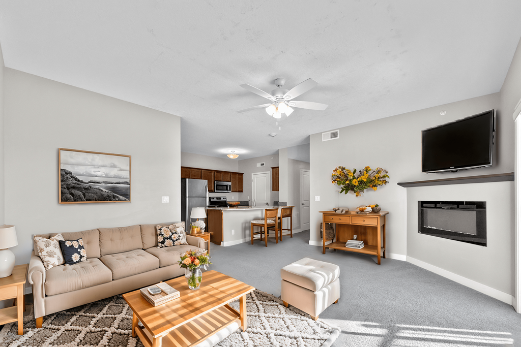 A living room with a couch, coffee table, and television.
