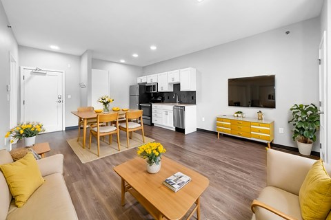 A modern living room with a wooden floor and furniture.