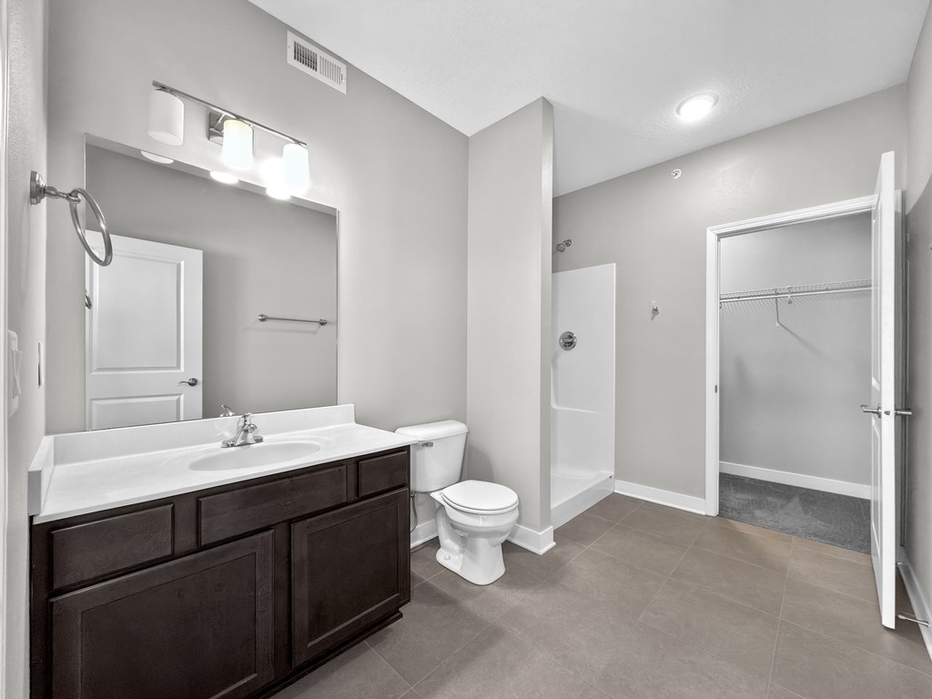 A bathroom with a white sink and a white toilet.