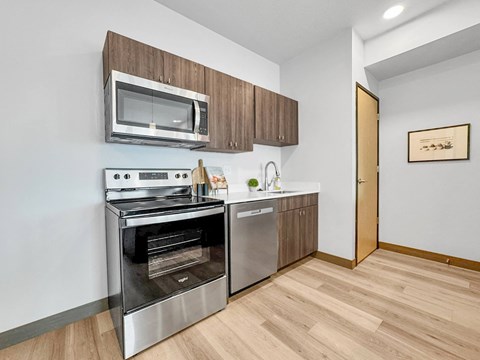 a kitchen with stainless steel appliances and a microwave