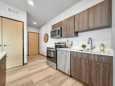 a kitchen with stainless steel appliances and wooden cabinets