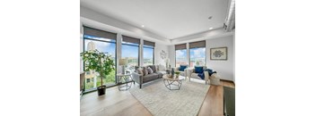 a living room with large windows and a rug