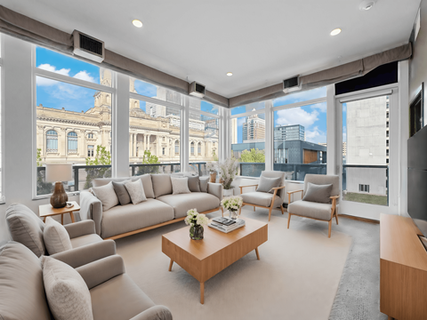 A living room with a large window overlooking a cityscape.