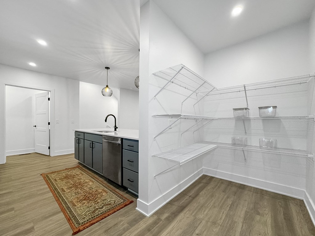 a renovated kitchen with a glass walk in shower and a counter with a sink