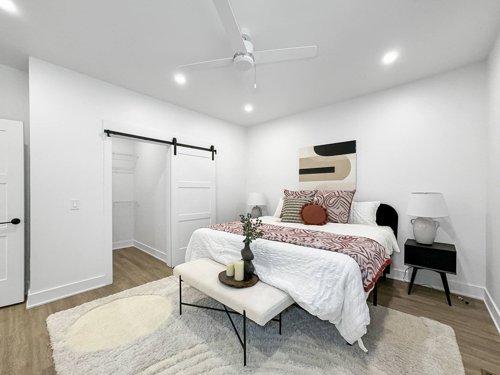 a white bedroom with a bed and a closet