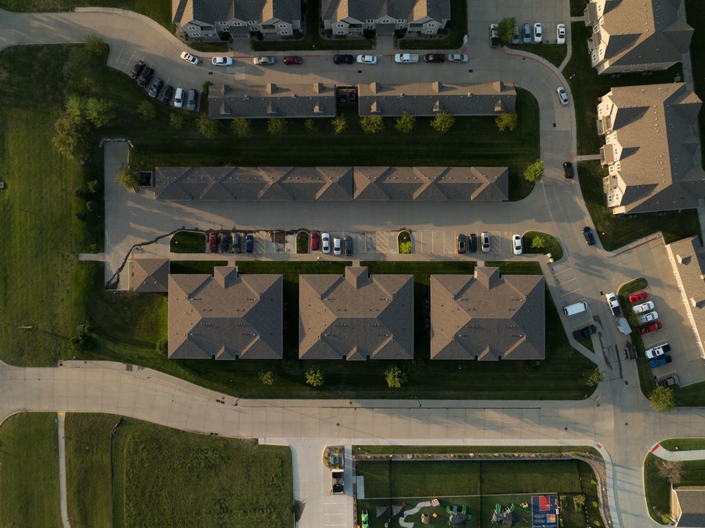 A bird's eye view of a residential area with houses and cars.