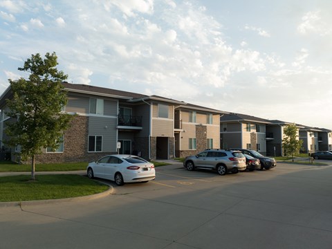 A white car is parked in front of a building.