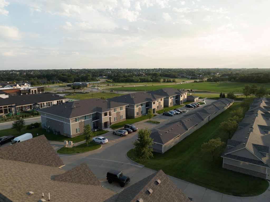 A large building complex with a parking lot in front.