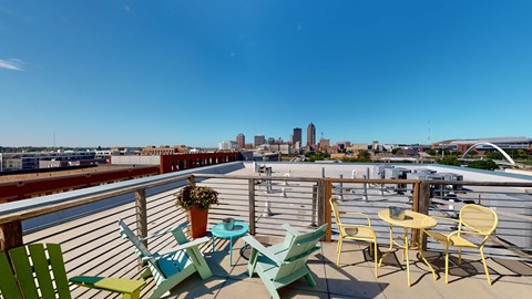A balcony with a view of the city skyline.