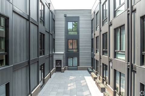 the courtyard of a condo building with a glass door in the middle