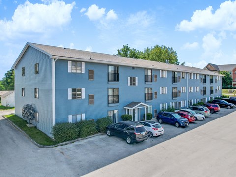 A blue building with cars parked in front.