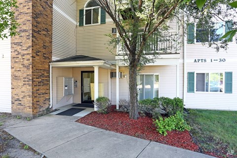 APTS 1-30 building with a tree in front.