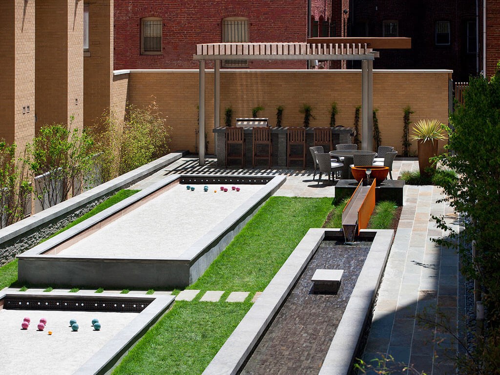 Courtyard with bocce courts, cozy lounges, gas grills and outdoor bar at Highland Park at Columbia Heights Metro, Washington, DC, 20010