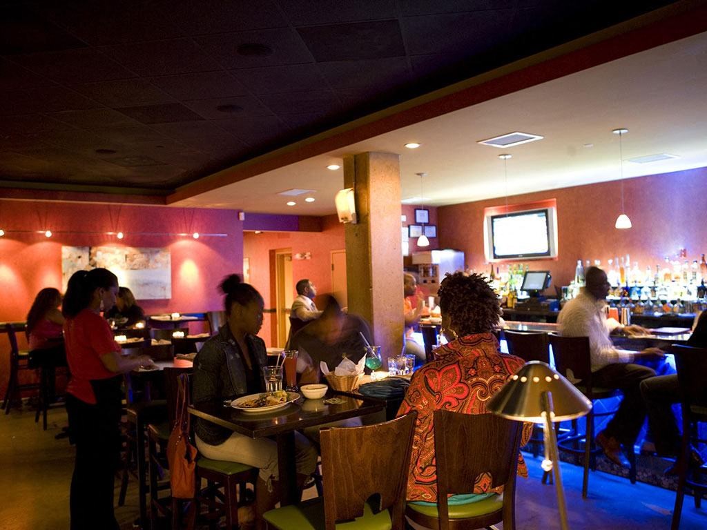 People eating at tables at Highland Park at Columbia Heights Metro, Washington, 20010