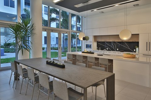 A modern kitchen with a dining table and chairs.