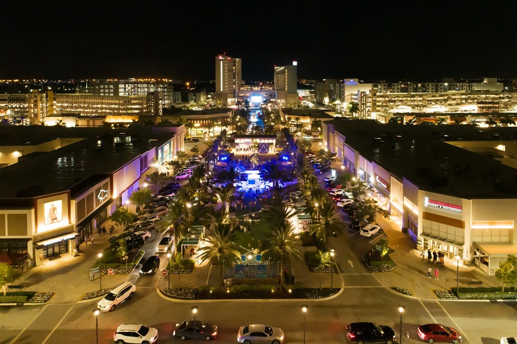 Heart of Dania Pointe at night, well lit, with cars lined up in Valet.