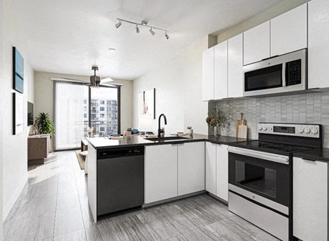 a kitchen with a stove and a sink and a microwave