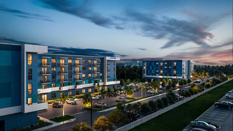 A modern building with a parking lot in front of it.