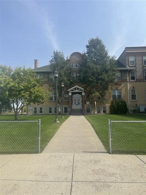 A building with a fence in front of it.