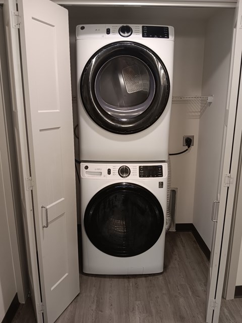 A white washing machine and dryer in a small laundry room.