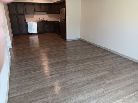 A kitchen with dark brown cabinets and a white dishwasher.