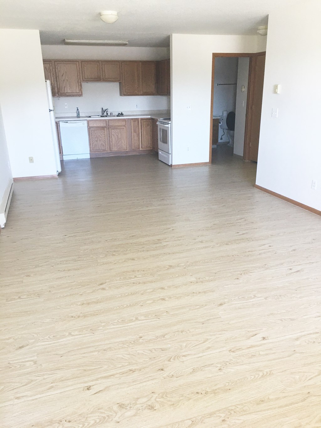 Image of Fridge, dishwasher, stove, sink, and bathroom