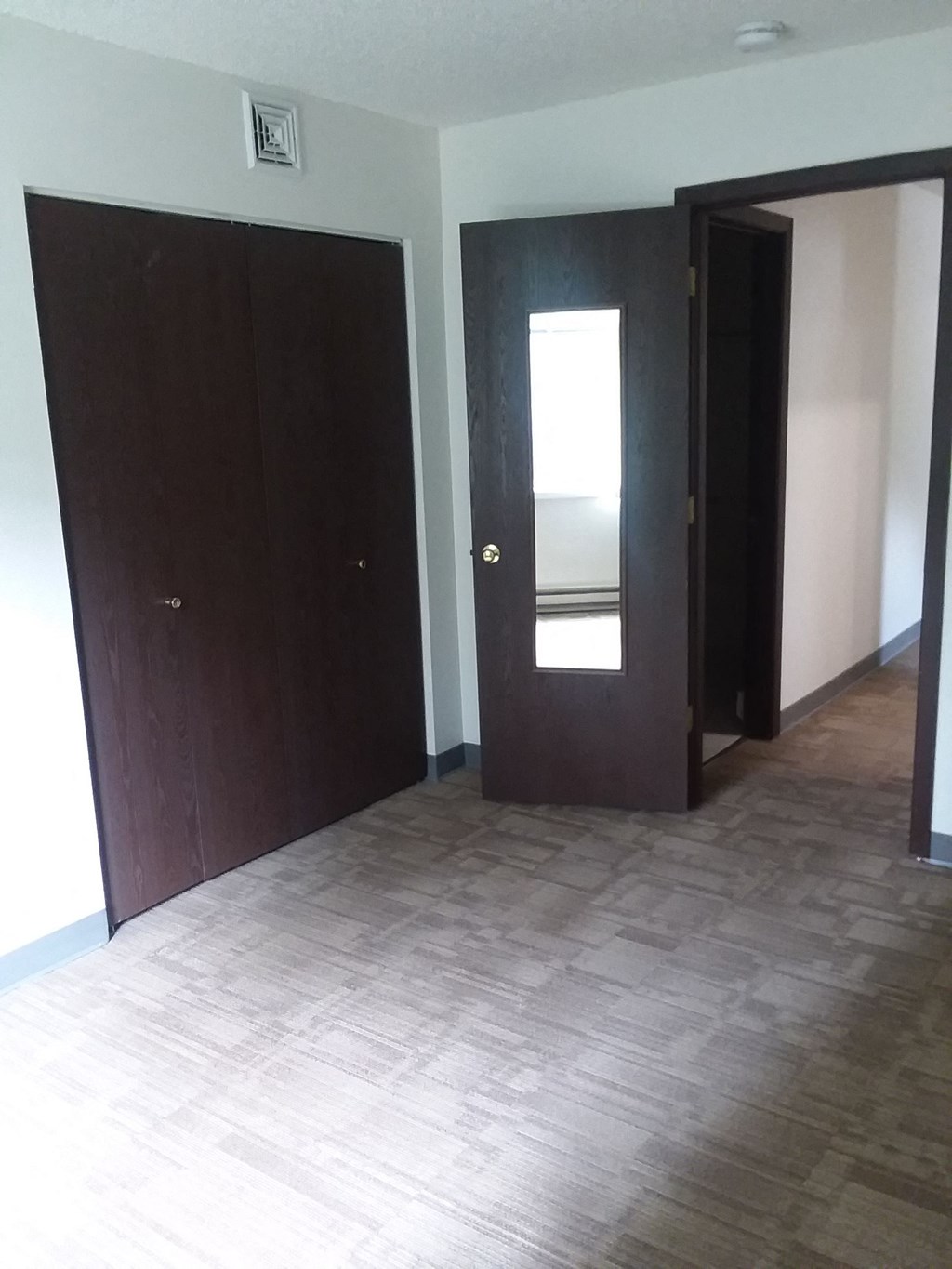 Bedroom Image of bedroom with closet and carpeted floor
