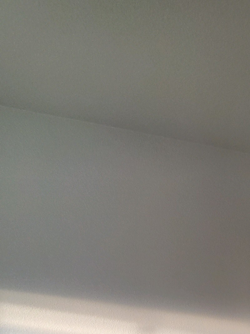 A room with a carpeted floor and a door.