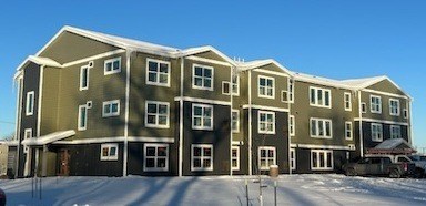 An image of Carter Commons with a lot of windows and a snowy ground.