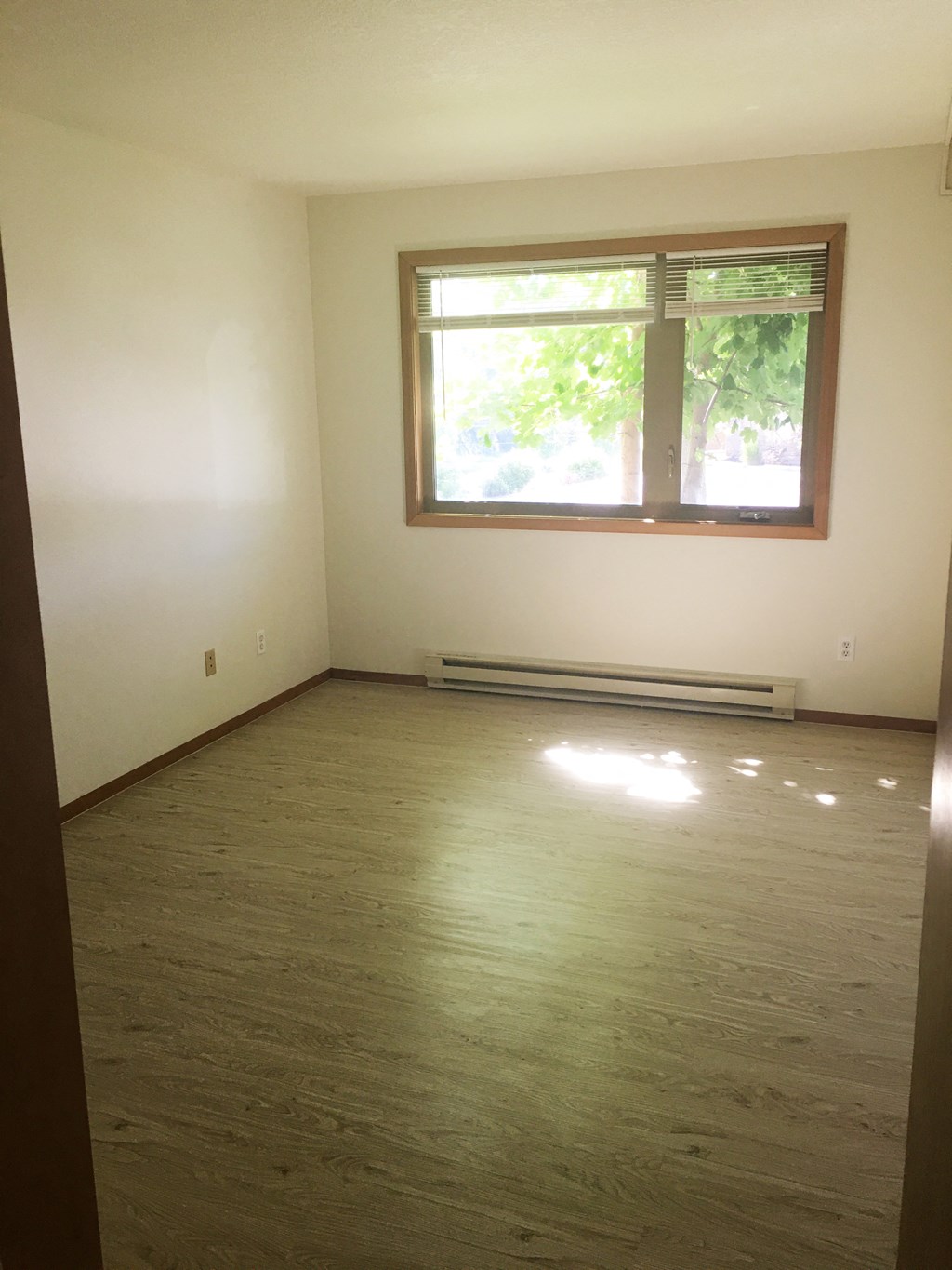 Image of bedroom with two windows and baseboard heater