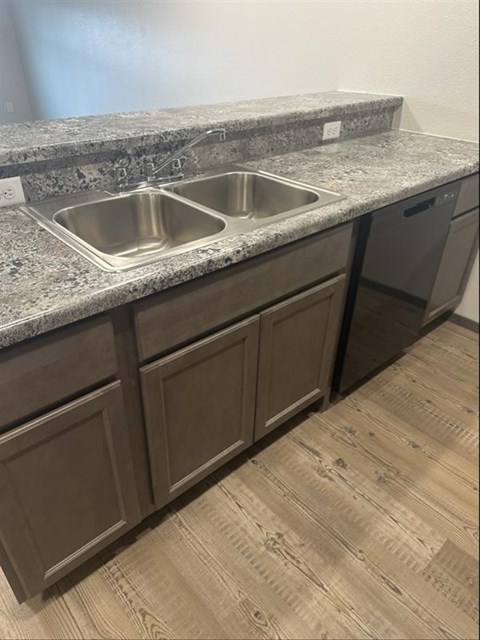 A kitchen with a granite countertop and a sink.