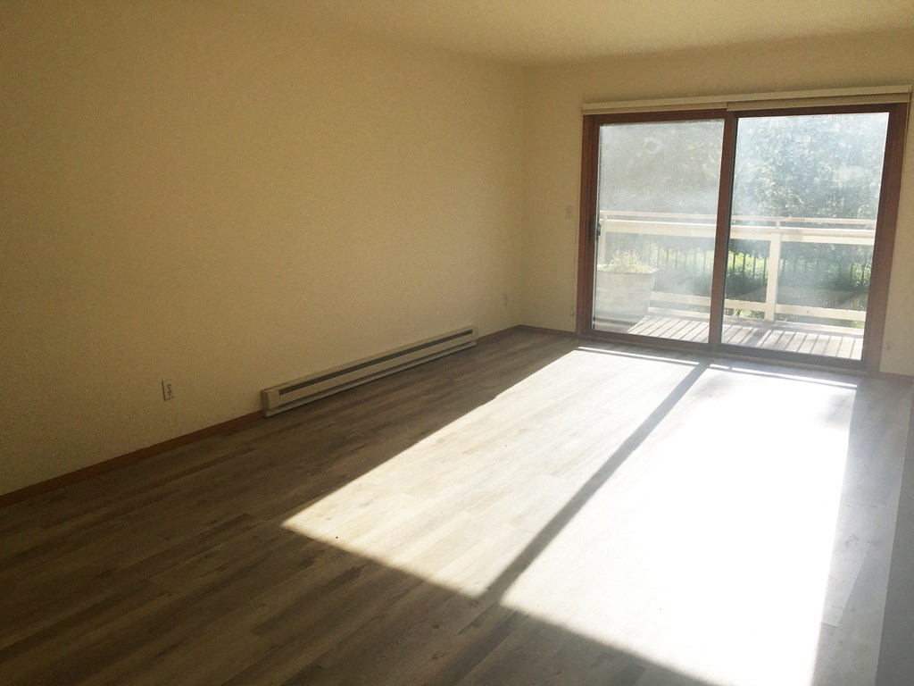 Image of living space with glass doors leading on to porch
