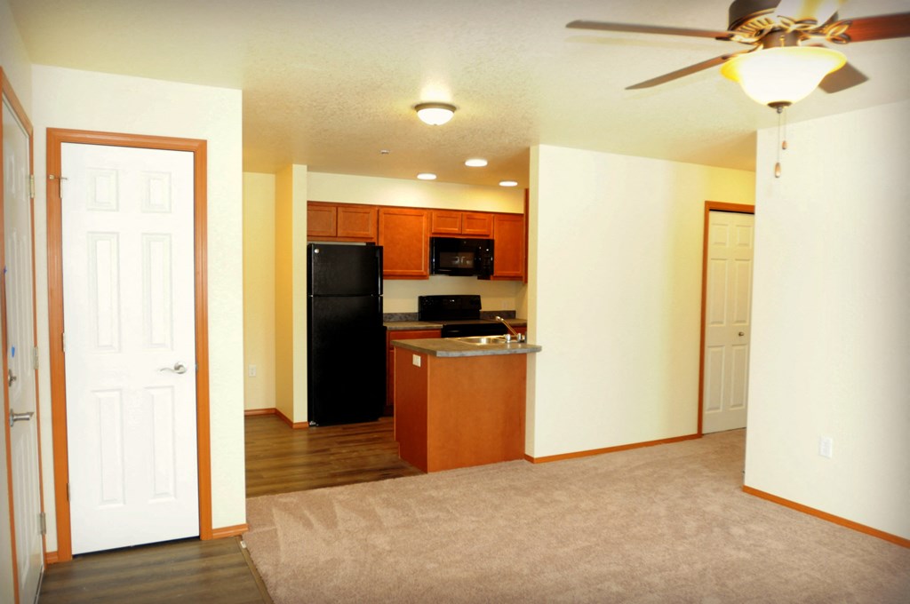 Kitchen and Open Space Image of refrigerator, stove, microwave, sink and cabinets