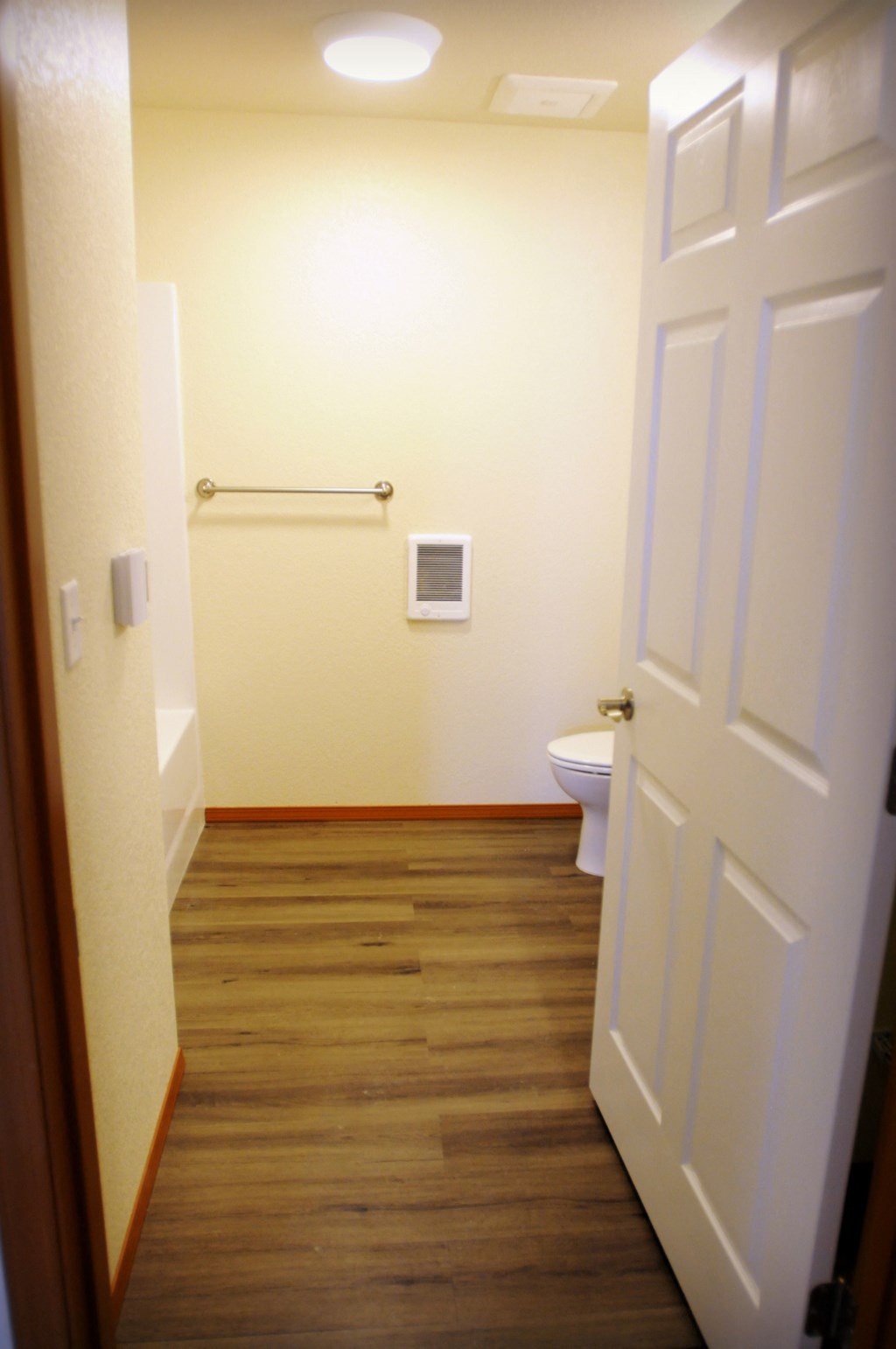 Bathroom Image of bathtub, towel rack, and toilet