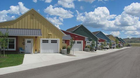 A row of units with a road in front.